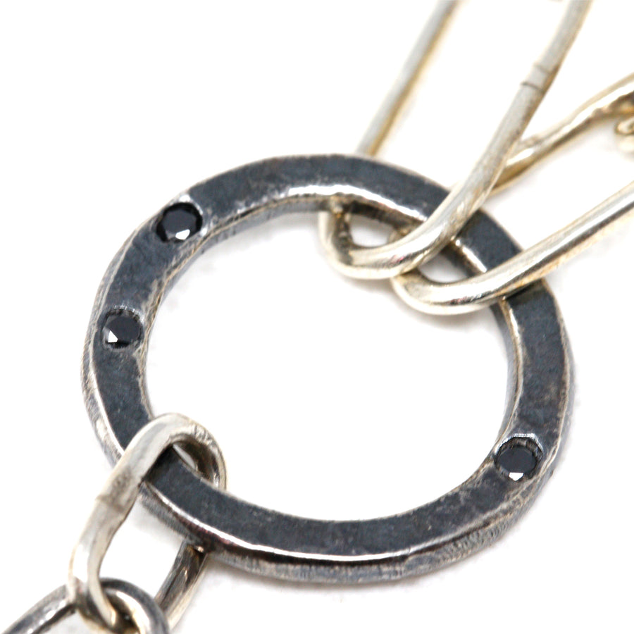 Woolly Mammoth fossil necklace with 14k gold, three black diamonds, and an all handmade sterling silver chain. The fossil itself—a small portion of the molar tooth—is from 14,000-60,000 years ago on the North American continent in Washington state. 