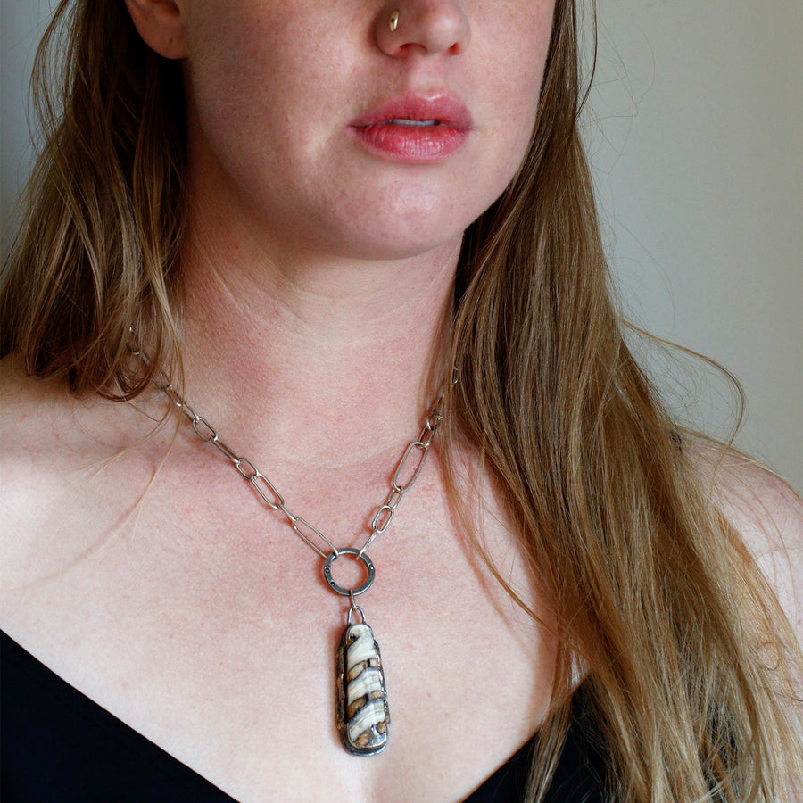 Woolly Mammoth fossil necklace with 14k gold, three black diamonds, and an all handmade sterling silver chain. The fossil itself—a small portion of the molar tooth—is from 14,000-60,000 years ago on the North American continent in Washington state. 