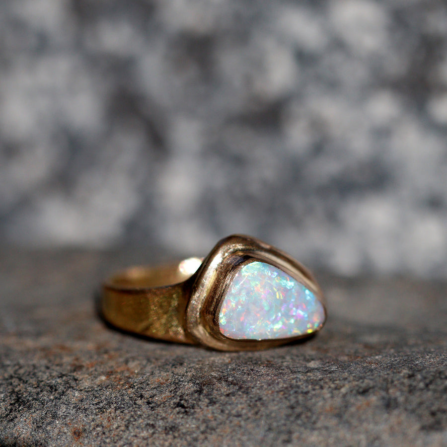 Gorgeous play of colors in this Australian Opal ring encased in recycled 14k gold. Shaped from raw opal originating from Lightning Ridge, Australia. Lightning Ridge opals are considered by many gemologists to be the finest opals in the world.  Ring size 6.75-7